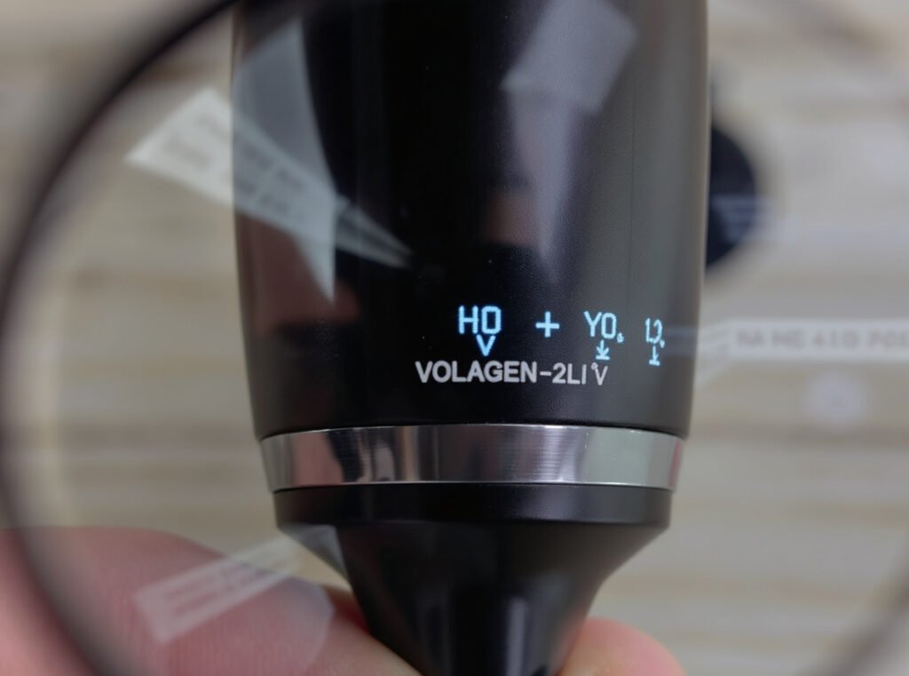Close-up view of hair dryer voltage label inspection with magnifying glass